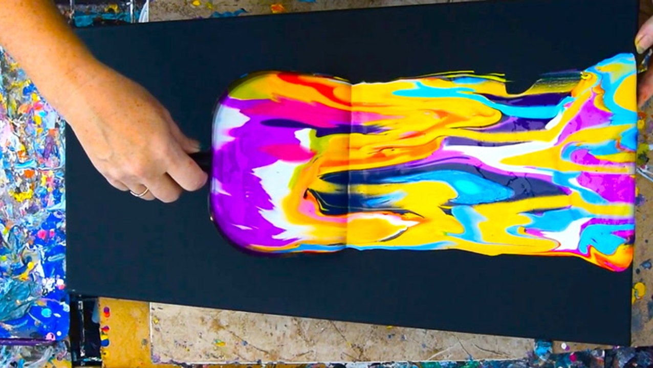 Artist creates fluid art with a dustpan