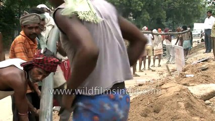 Workers lay underground cable in Delhi - archaic method for modern tech