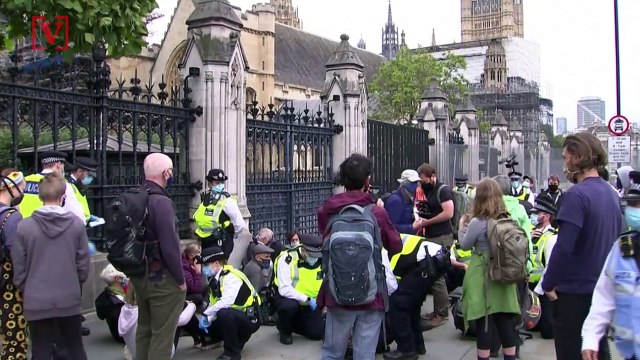 Climate Change Activists Glue Themselves to Sidewalk in Protest