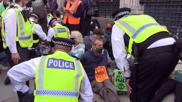 Extinction Rebellion protesters glue themselves outside UK Parliament