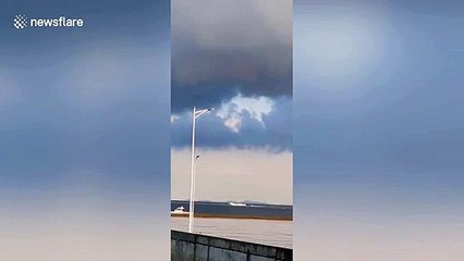 Huge waterspout swirls over sea in northern China
