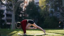Pretty girl doing yoga  in the park. Fitness girl training outdoors in landscape of nature.