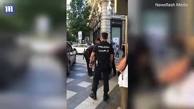 Madrid officers force woman into police car for not wearing a mask