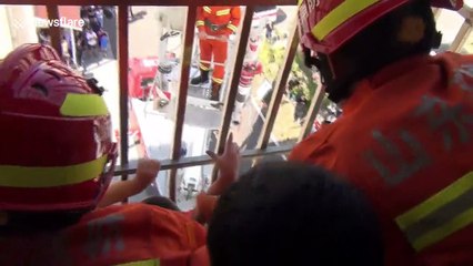 Firefighters save 6-year-old hanging from fourth-floor window in eastern China