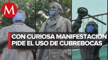 En Oaxaca, activista coloca cubrebocas en monumentos para fomentar su uso