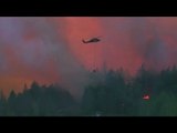 Raging wildfires destroy Washington town, roar through California, Oregon