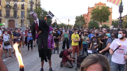 Catalan separatists burn effigy of king at annual demonstration to mark region's National Day