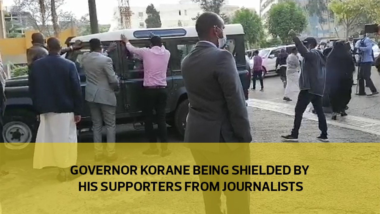 Governor Korane being shielded by his supporter...