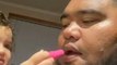 Kid Puts Lipstick on Dad's Lips While He Tries to Act Tough on Camera