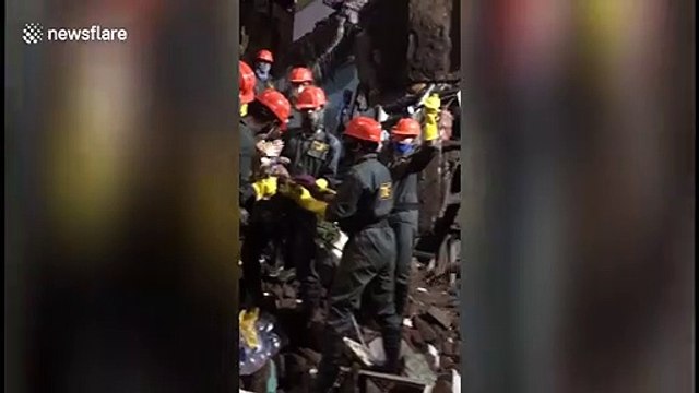 Moment child rescued from underneath debris of collapsed building in western India