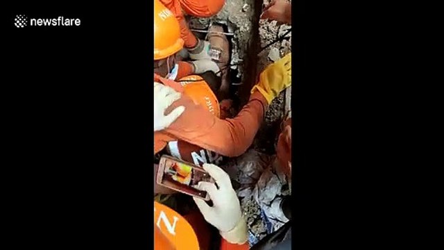 Moment man rescued from underneath rubble of collapsed building in western India