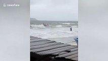 Fisherman rescued after capsizing in waves during Typhoon Noul in Cambodia