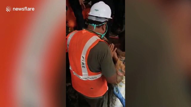 Moment woman rescued from collapsed building in western India