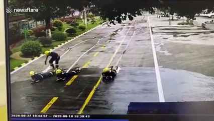 Chinese firefighters left soaked after colleague loses control of water hose during training