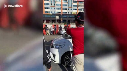 Driver survives unscathed after concrete barrier falls 60ft onto her car in Malaysia