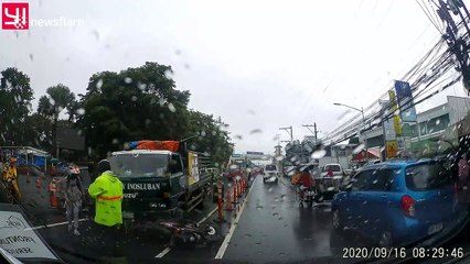 Helmet saves motorcyclist's life after he falls under truck's wheels in the Philippines