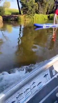 Boat Wake Rocks Paddle Board Rider