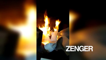 Elderly couple burns books in fireplace in protest
