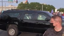 US President Donald Trump waves at supporters in motorcade outside hospital