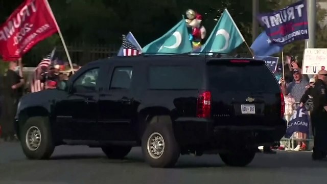 Donald Trump waves to supporters from motorcade after he is discharged from hospital after contracting Covid-19