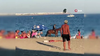 Atını denize süren kovboy, tatilcileri şaşkına çevirdi