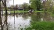Truck drives in deep water with a boat VIDID - VID ID