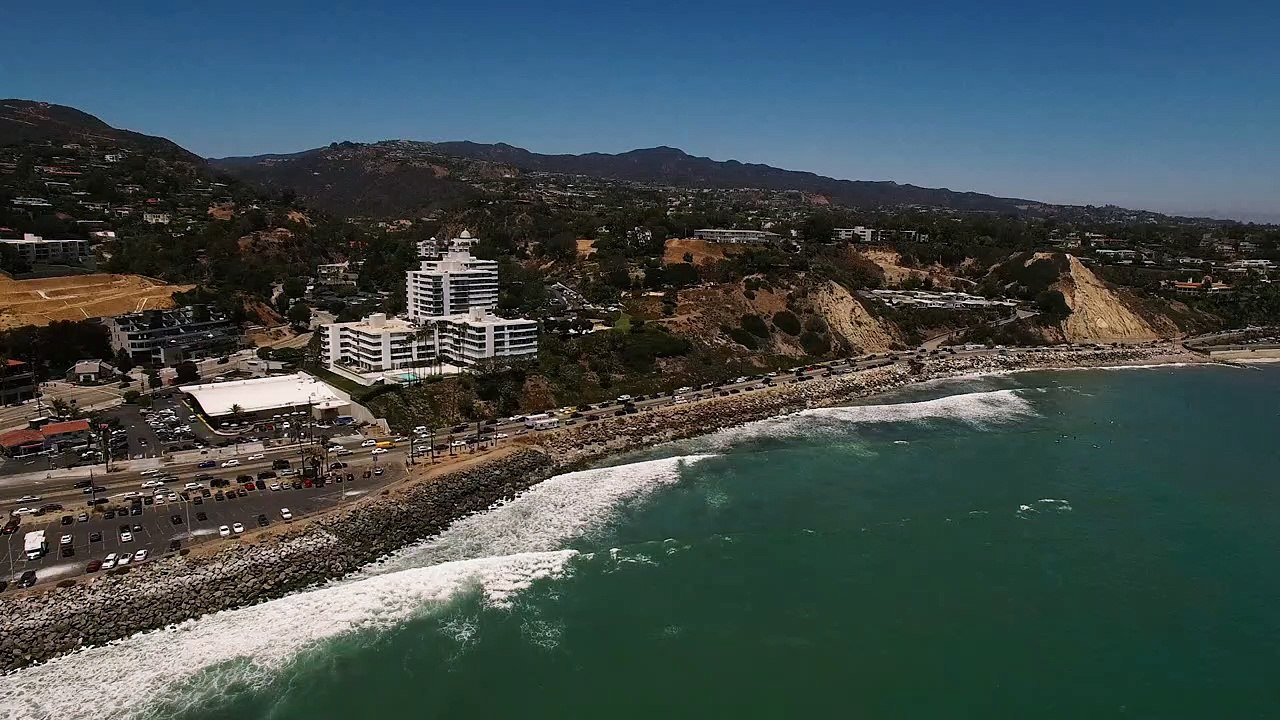 Cars driving by Malibu Beach - Free Stock Video - Mixkit