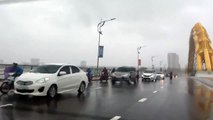 Tài xế ô tô đi chậm để chắn mưa to gió lớn cho xe máy đi qua cầu Rồng