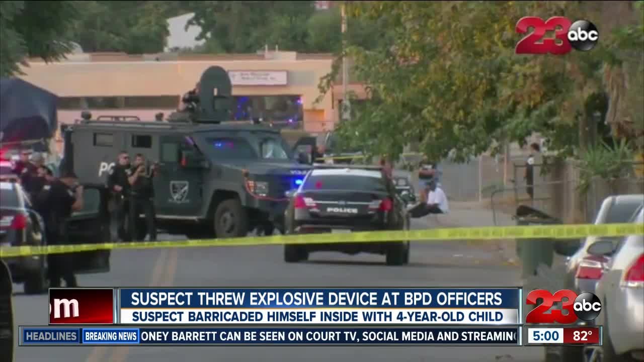 Man barricades himself inside home with child a...