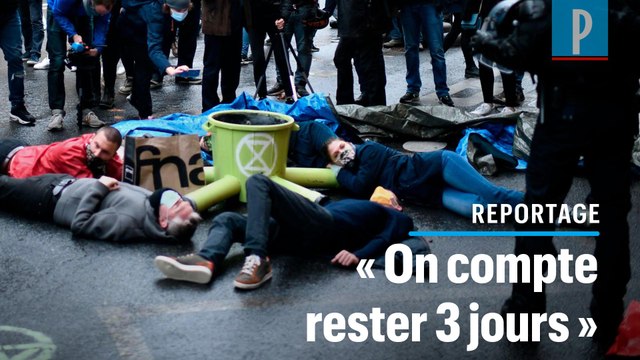 Extinction Rebellion : des militants s'attachent au sol pour l'urgence climatique