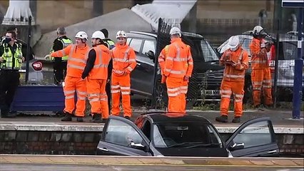 Workers remove a car from the tracks at Stirling Railway Station