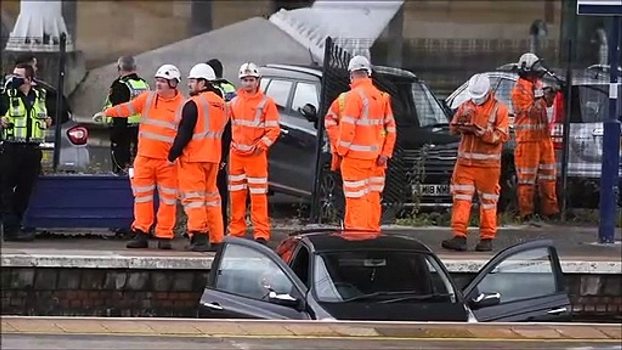 Workers remove a car from the tracks at Stirlin...