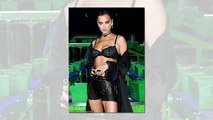 Irina Shayk keeps a low profile in a black Burberry hoodie and pleated skirt
