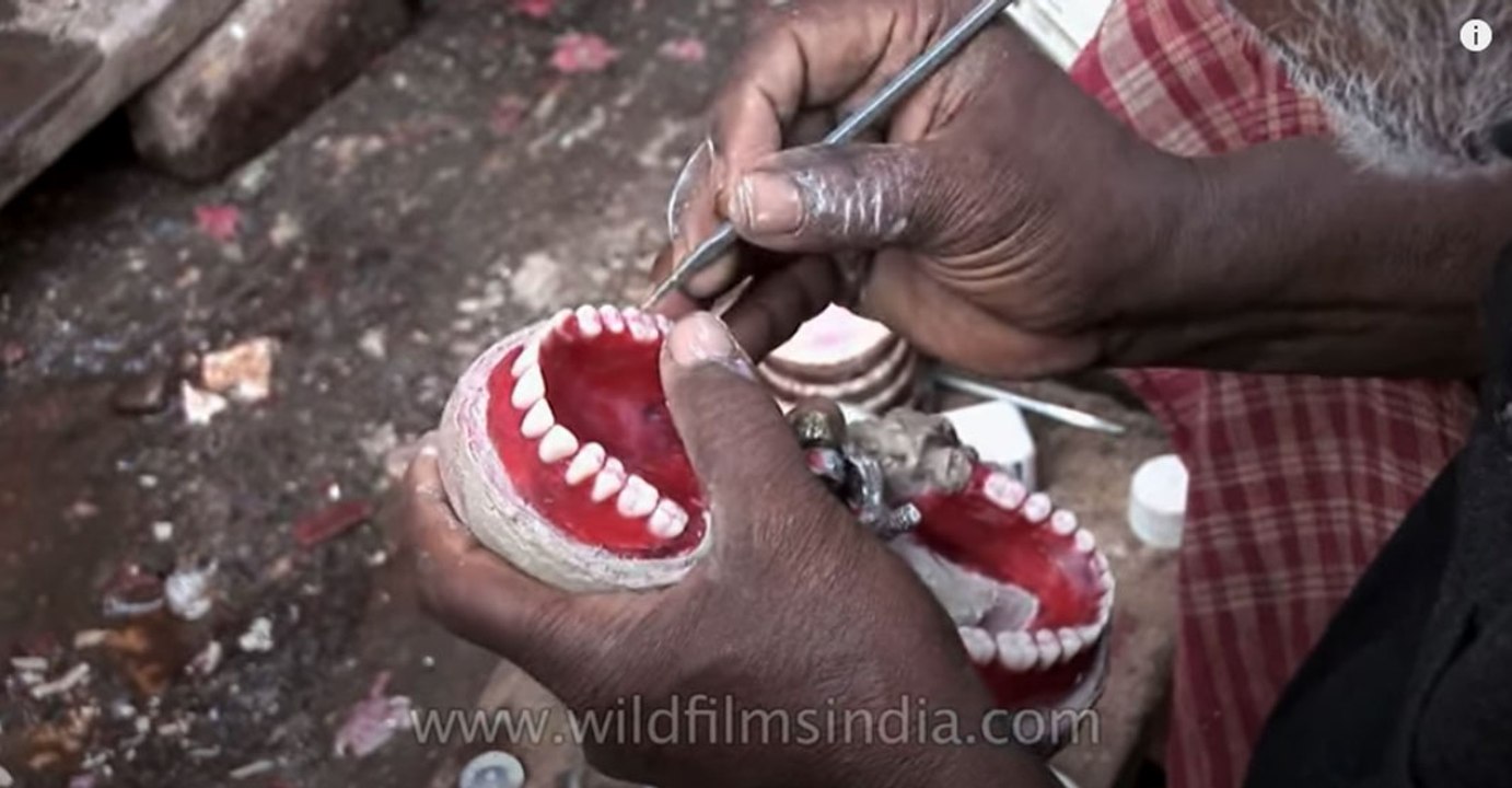 Roadside dentist shows how he makes false teeth