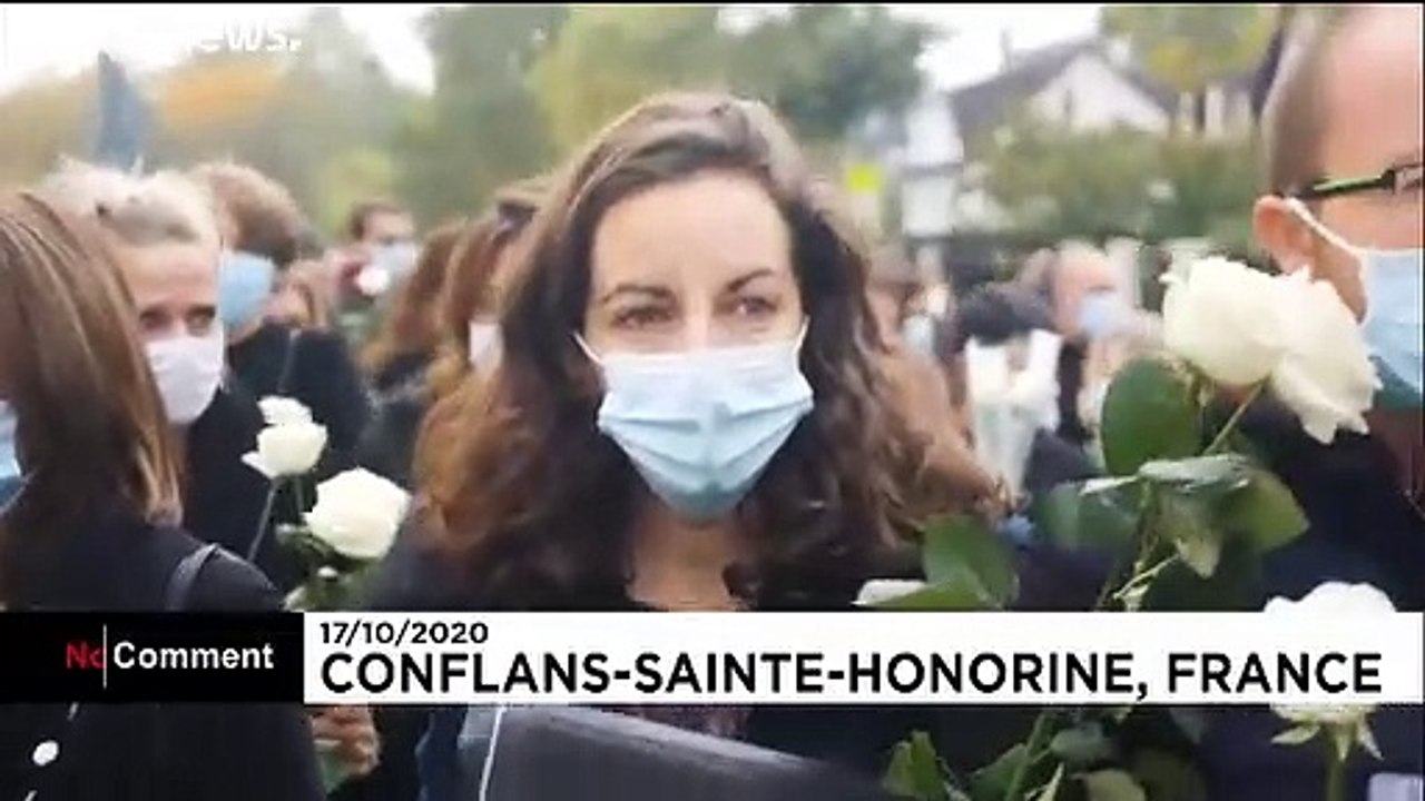 People pay tribute to beheaded teacher outside school where attack took place