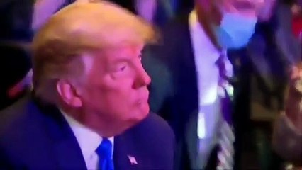 Trump puts wad of cash into the collection box at church in Las Vegas.