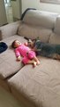 baby girl hugs australian cattle dog on couch - cattle dog leads rescuers to lost little girl