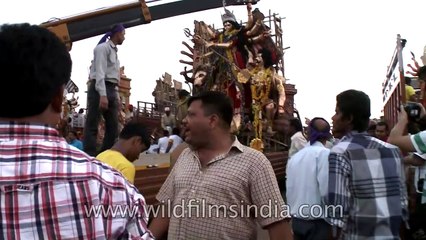Cranes are being used during Durga Visarjan
