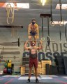 Guy Stands on Friend's Shoulders While They do Weightlifting