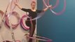 Woman Stands On One Leg And Spins Hula Hoops Around Arms And Legs