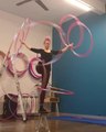 Woman Stands On One Leg And Spins Hula Hoops Around Arms And Legs
