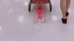 Toddler Lies on Floor Holding Shopping Cart Enjoying a Slide Ride as Dad Pushes It Through Aisle