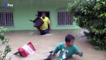 Guatemalans carry belongings, pets, through floods as storm Eta hits