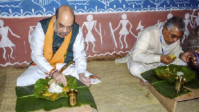Shah eats lunch at the house of a Matua Community member