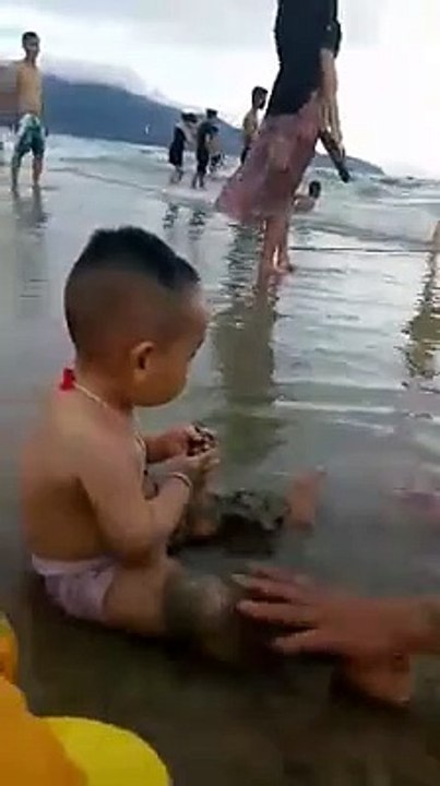 Cute and Funny Baby Playing on the Beach