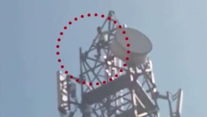 Man climbs tower after argument with wife