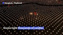 Thailand: Buddhist monks light candles on Visakha Bucha Day