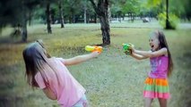 Two companions directing a game fight with water guns
