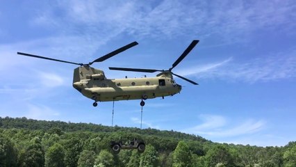 U.S. Soldiers Sling load a Humvee to a CH-47 Chinook Helicopter