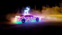 Race Car Decorated With LED Lights for Christmas Does Donuts on Street